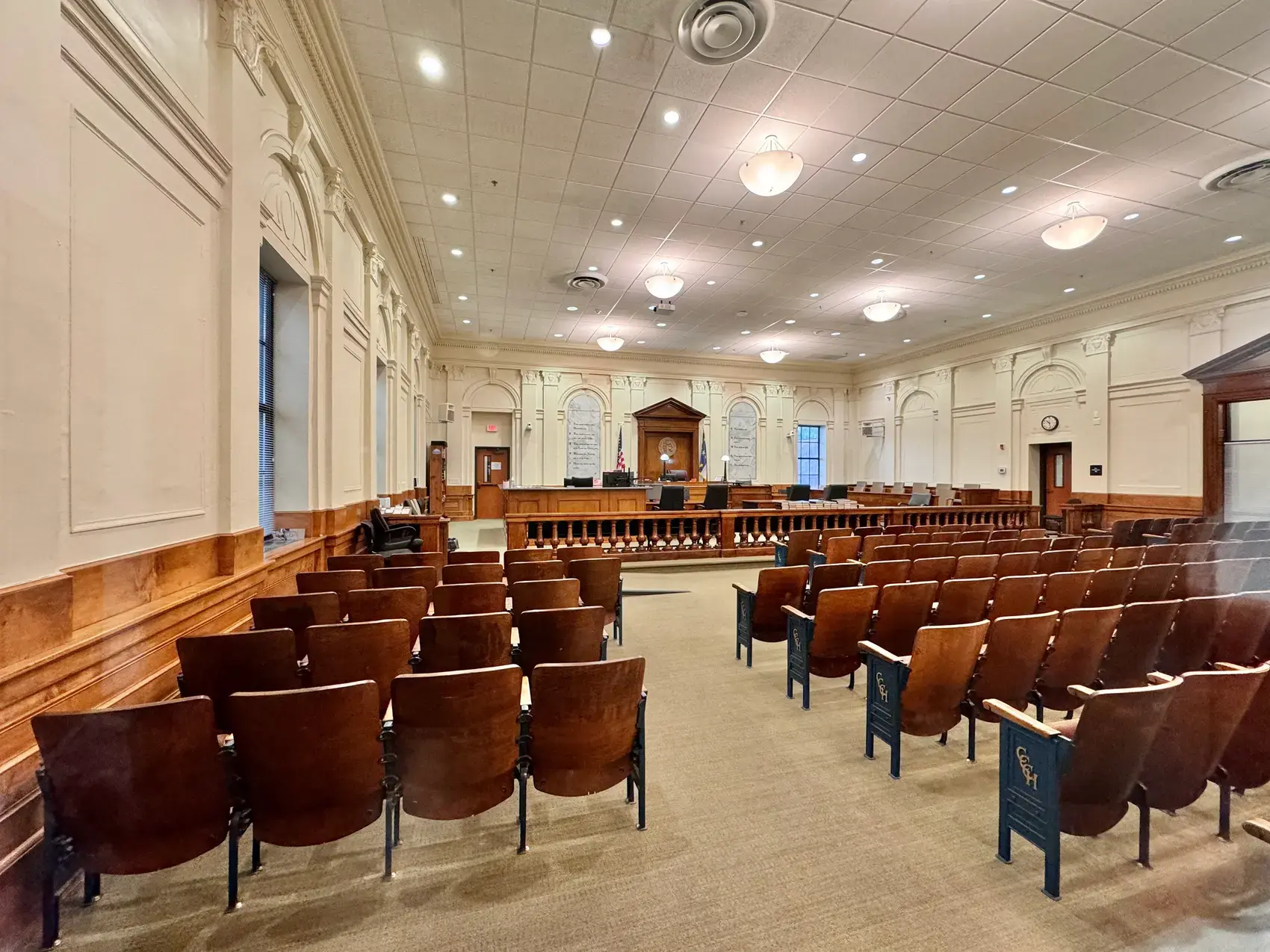 Rows of seating facing the bench in a county courtroom